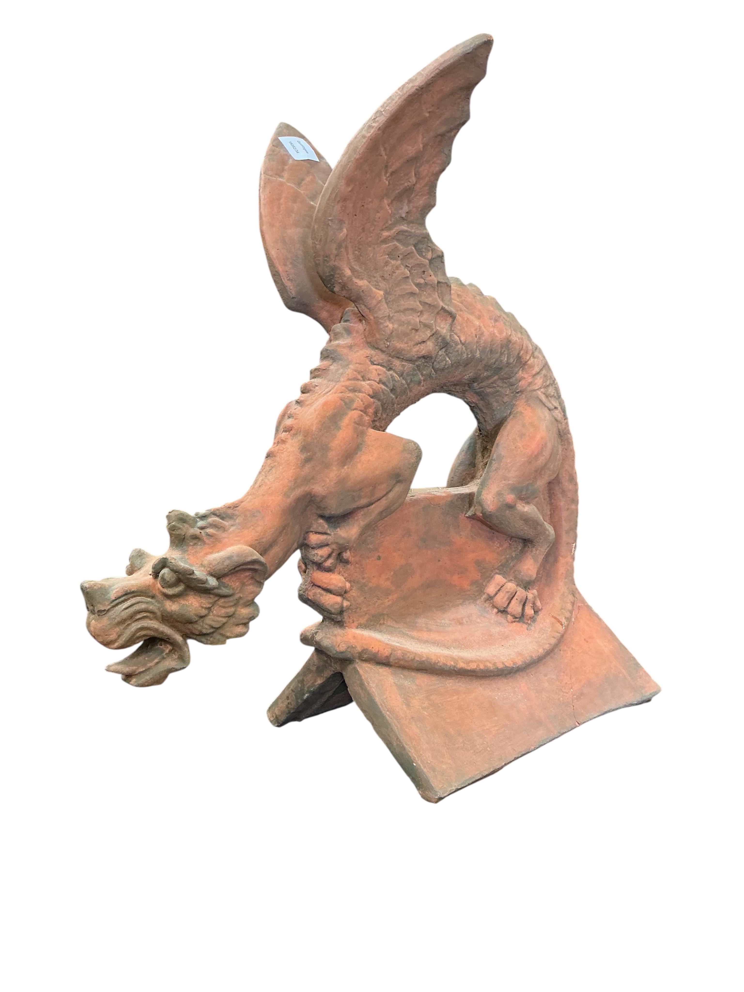 A terracotta gargoyle ridge tile, height 66cm